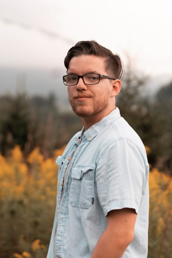 A photo of a man (Ian Willett) posing seriously in a field